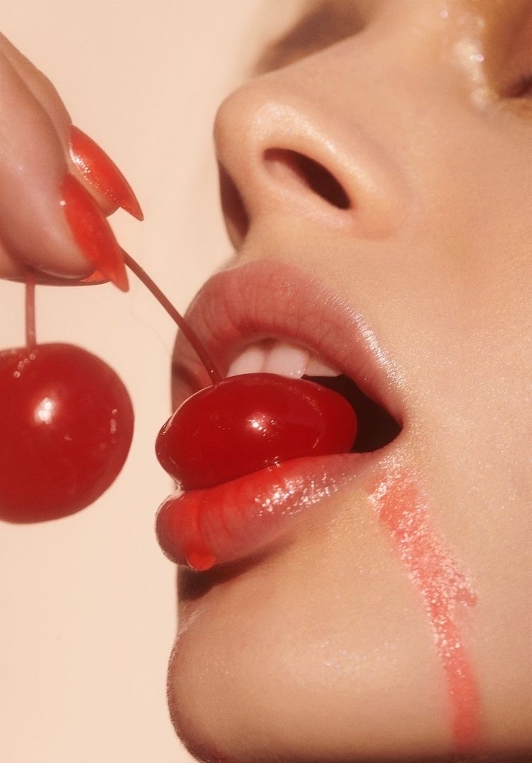 Woman Biting A Cherry
